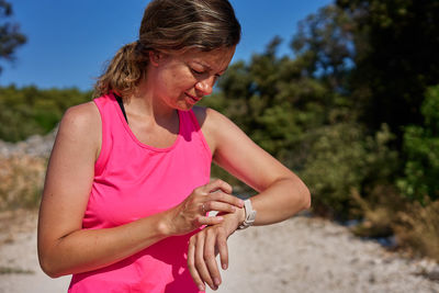 Side view of young man with arms raised