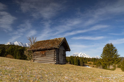 Built structure on field against sky