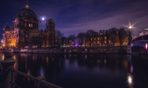 River by berlin cathedral in illuminated city at night