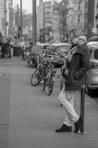 Man with bicycle on street in city