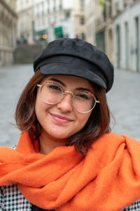 Portrait of smiling young woman in city