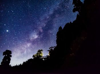 Scenic view of mountains against sky at night