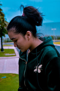 Portrait of a young woman looking away