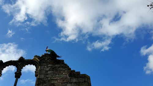 Low angle view of old building against blue sky