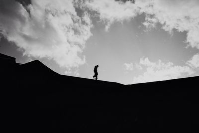 Low angle view of silhouette people against sky