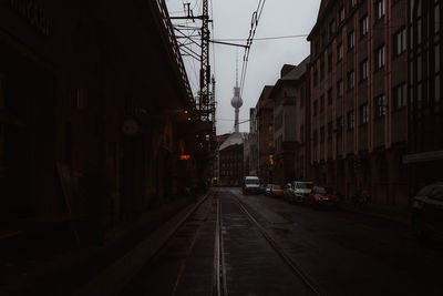 Cars on street amidst buildings in city