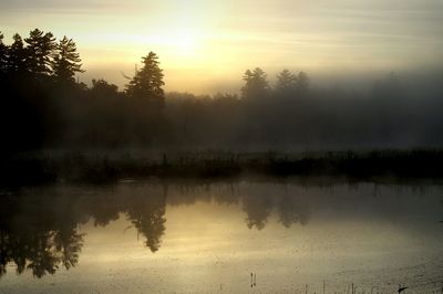 Scenic view of lake at sunset