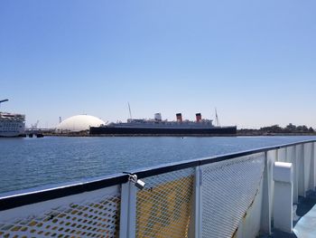 Ship sailing in sea against clear sky