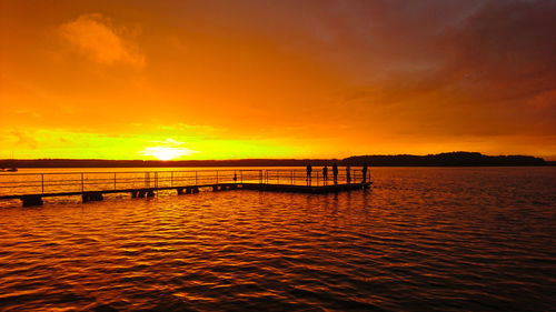 Scenic view of sea against orange sky