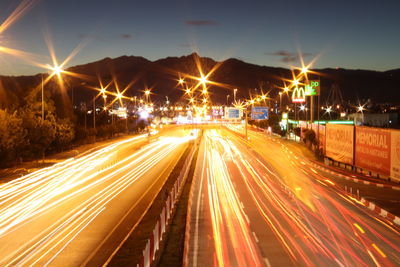 High angle view of light trails on road at night