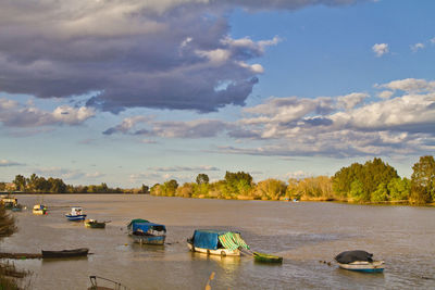 Boats moored in sea against sky