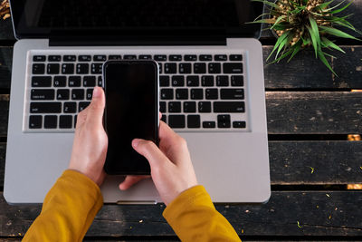 Midsection of woman using mobile phone