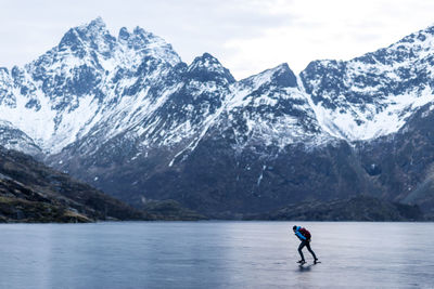 Full length of person on snowcapped mountain against sky