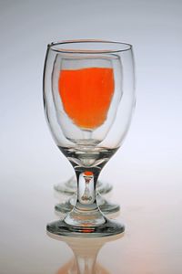 Close-up of beer glass against white background