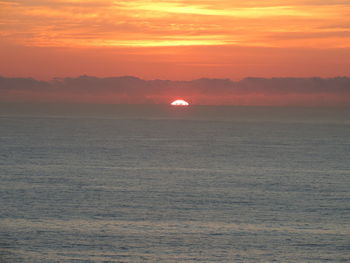 Scenic view of sea against romantic sky at sunset