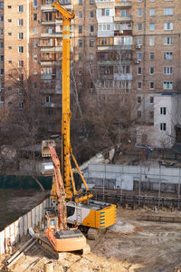 Construction site by buildings in city