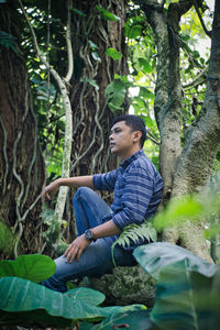 Side view of young man looking at park