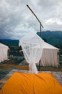 White umbrella hanging on mountain against sky