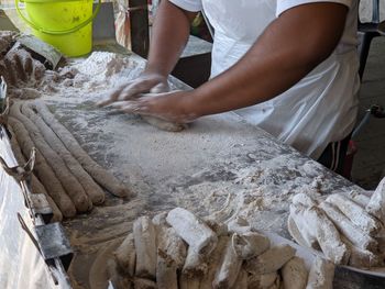 Midsection of man preparing food