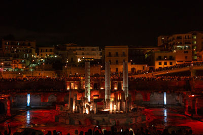 High angle view of illuminated buildings in city at night