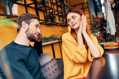 Young couple sitting in restaurant