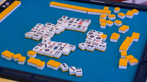Many mahjong tiles on the playing field. an ancient asian game called mahjong. 