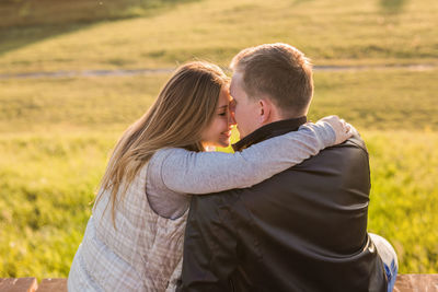 Couple kissing on field