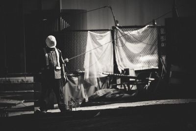 Full length of manual worker standing on road in city