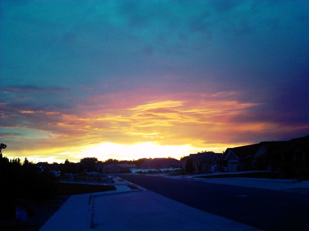 sunset, sky, orange color, cloud - sky, building exterior, architecture, built structure, cloud, scenics, beauty in nature, silhouette, dramatic sky, tranquility, tranquil scene, nature, moody sky, cloudy, dusk, road, outdoors