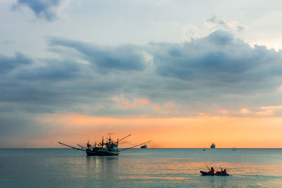 Boat sailing in sea at sunset