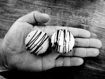 Cropped image of hand holding sweet food