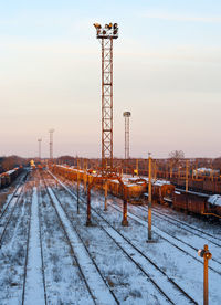 Railroad tracks against sky during winter