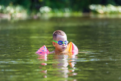 Boy swimming in lake