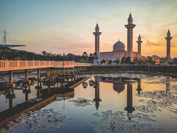 Reflection of buildings in water at sunset