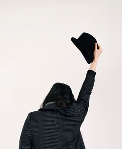 Low angle view of person holding camera against sky