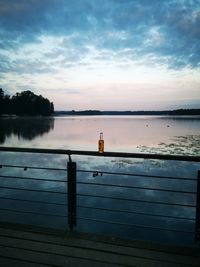 Scenic view of lake against sky at sunset