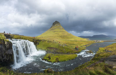 Scenic view of waterfall against sky