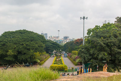 People in park against sky in city