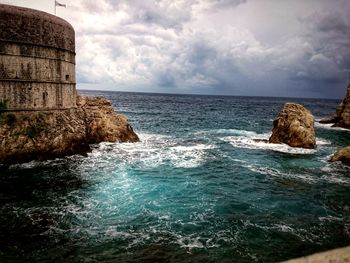 Scenic view of sea against cloudy sky