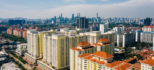 High angle view of modern buildings in city against sky