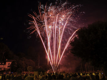 Low angle view of firework display at night