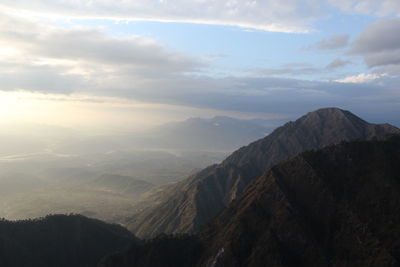 Scenic view of mountains against cloudy sky