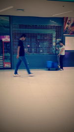 Full length of woman standing by railing