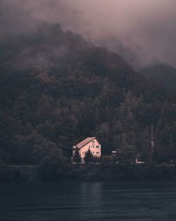 Scenic view of lake by buildings against sky