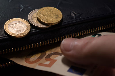 Close-up of hand holding coins