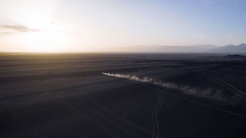 Scenic view of land against sky during sunset