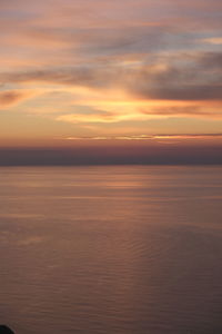 Scenic view of sea against orange sky