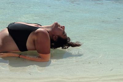 High angle view of woman lying in swimming pool