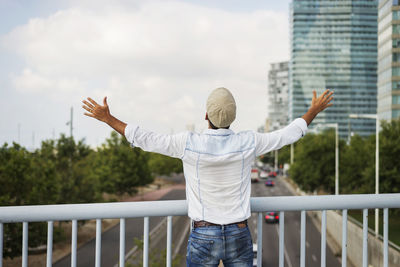 Rear view of man with arms outstretched