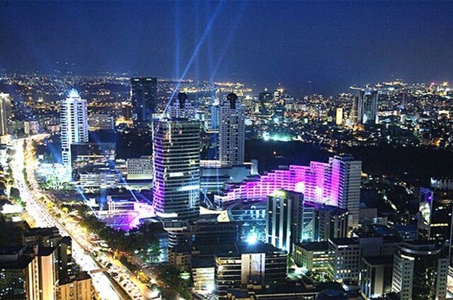 ILLUMINATED CITYSCAPE AGAINST SKY